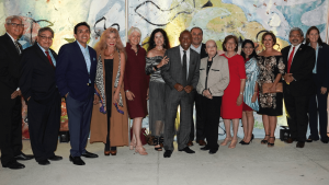 A group of community leaders, artists, and advocates—including Dr. Dorothy Caram and Houston Mayor Sylvester Turner—pose together at the ALMAAHH kick-off event. The group stands in front of a colorful mural, celebrating the launch of Houston’s Latino museum and cultural arts initiative.